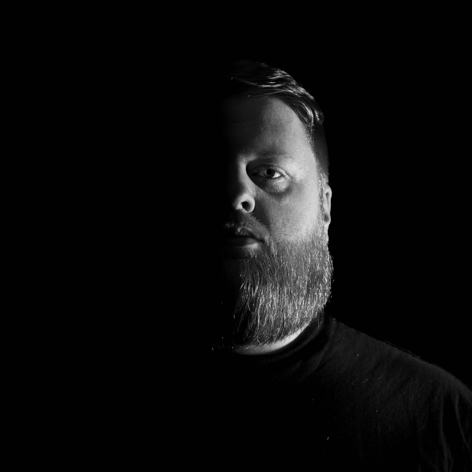 Lewis Cleveland — black and white portrait, one side of the face lit against a dark background